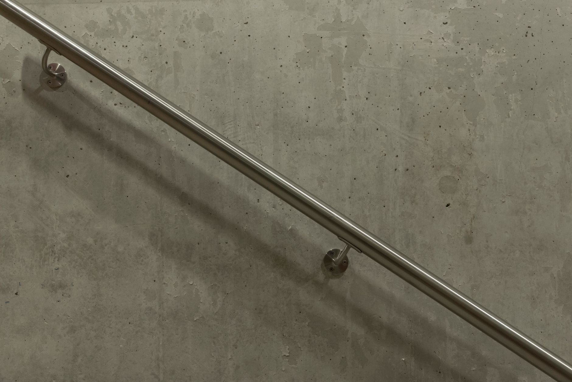 A stainless steel balustrade beside a staircase