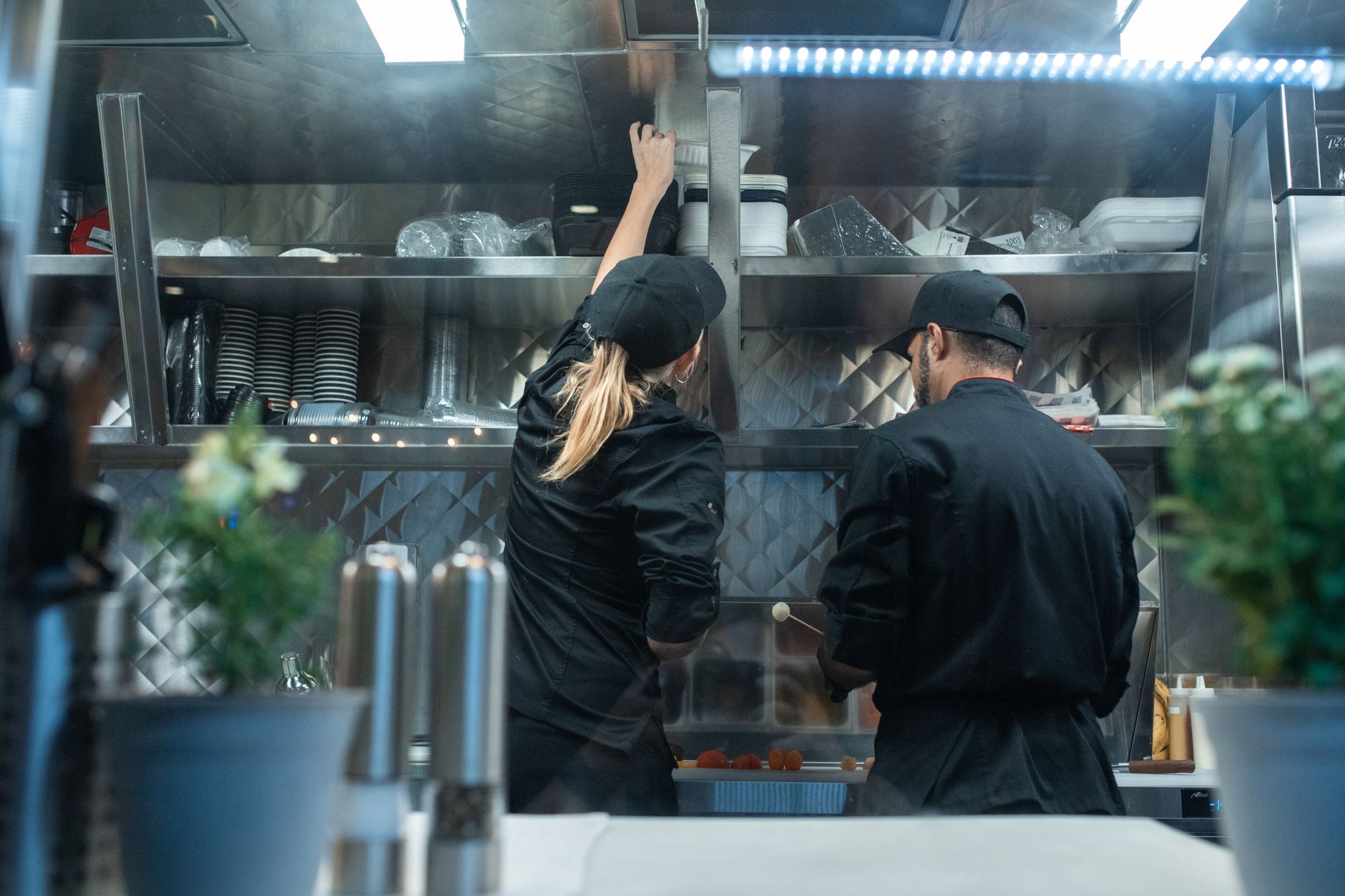 A stainless steel commercial kitchen bench and shelving